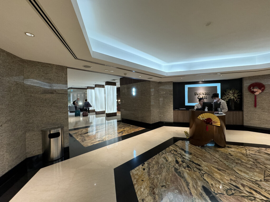 a lobby with a reception desk and people in the background