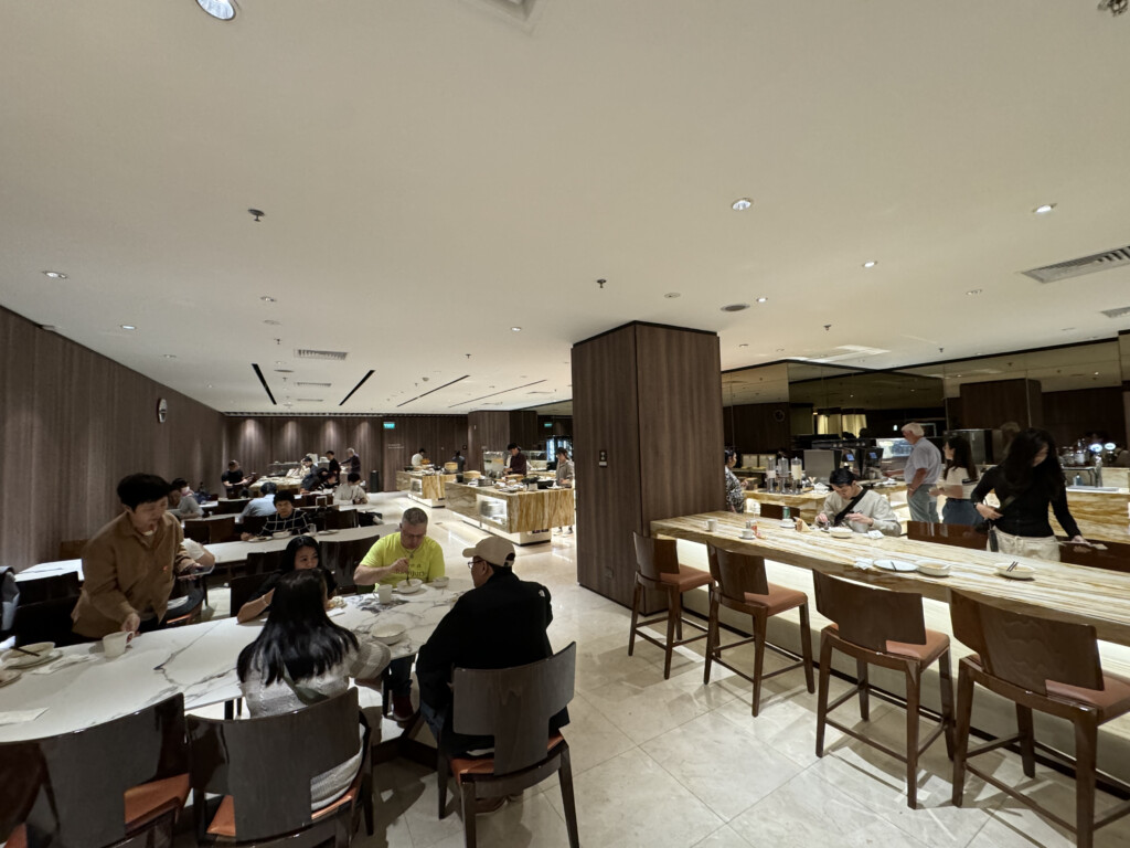 a group of people sitting at tables in a restaurant