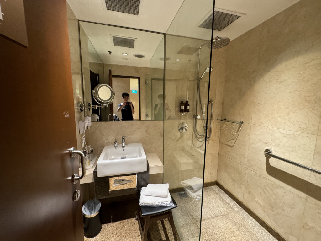 a bathroom with a glass shower and sink