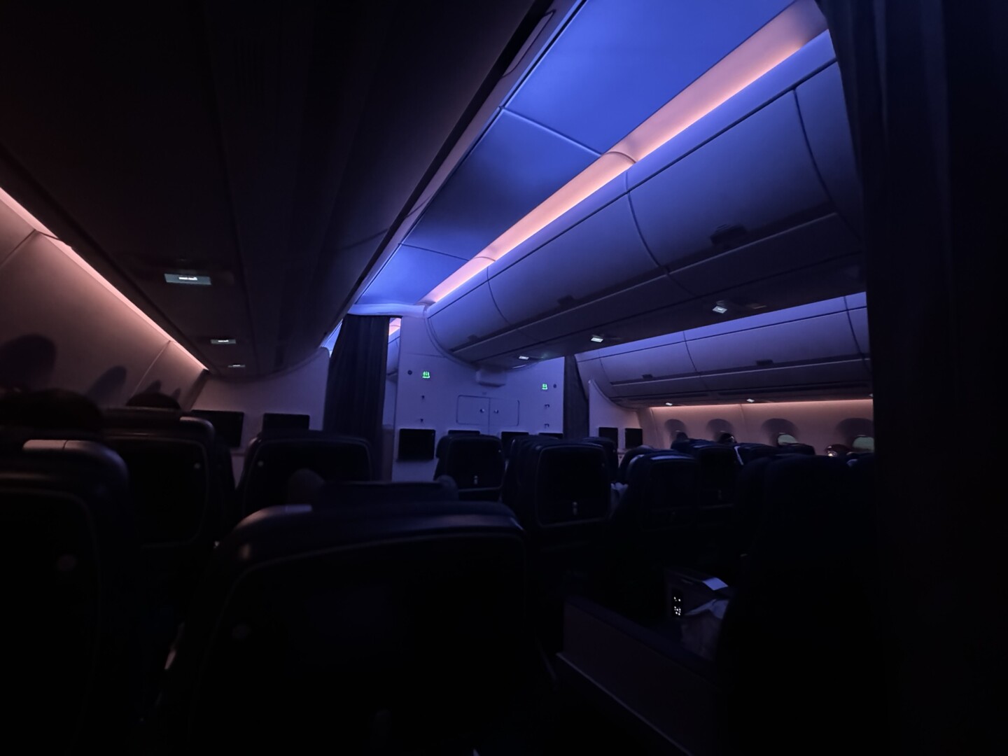 inside an airplane with seats and lights