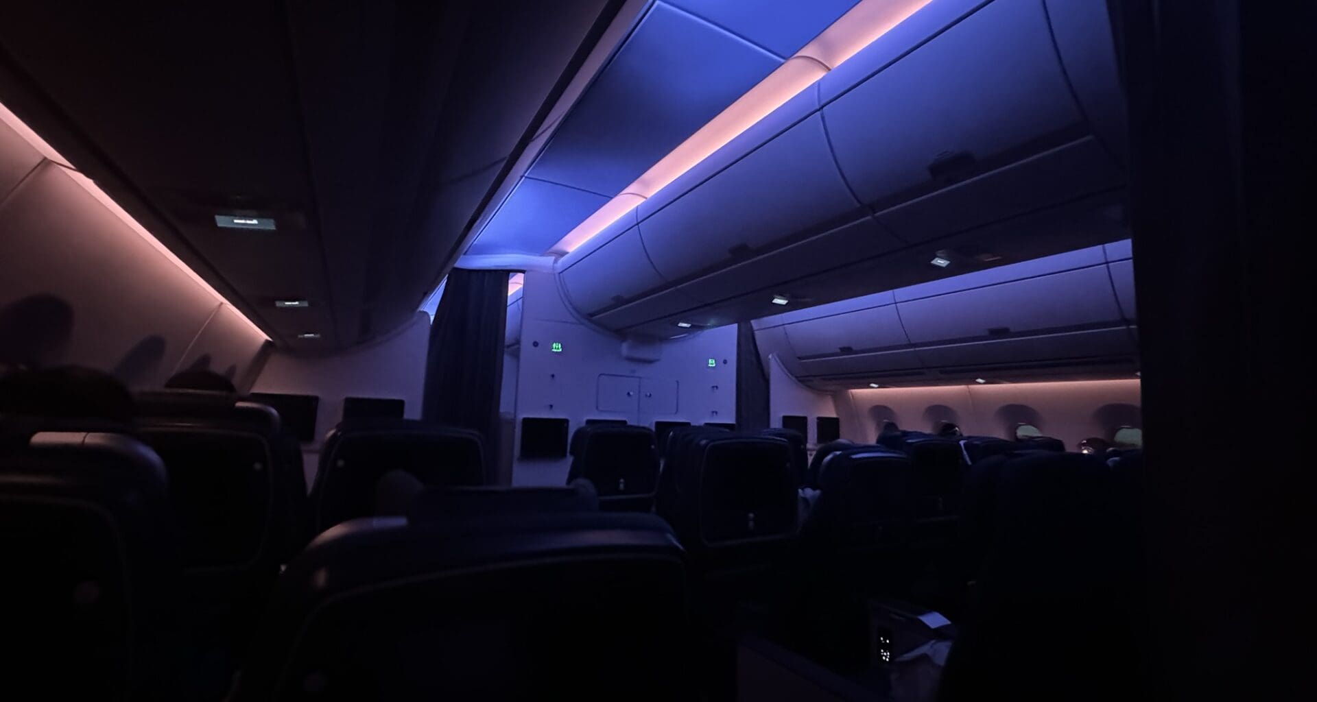 inside an airplane with seats and lights