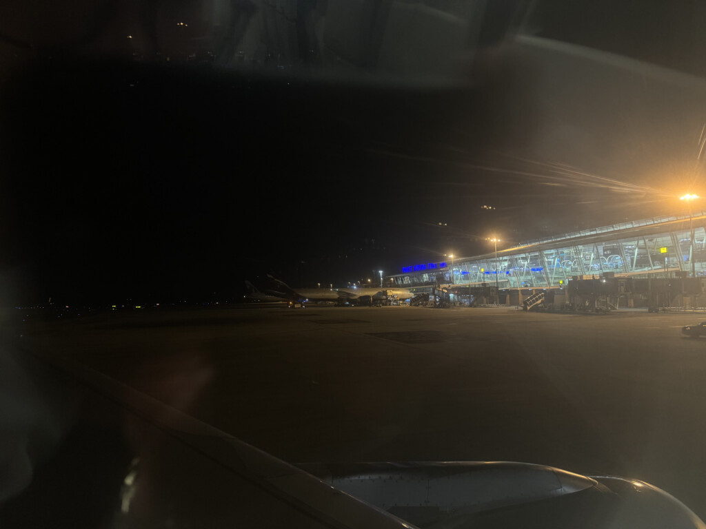 a view of an airport from a window at night