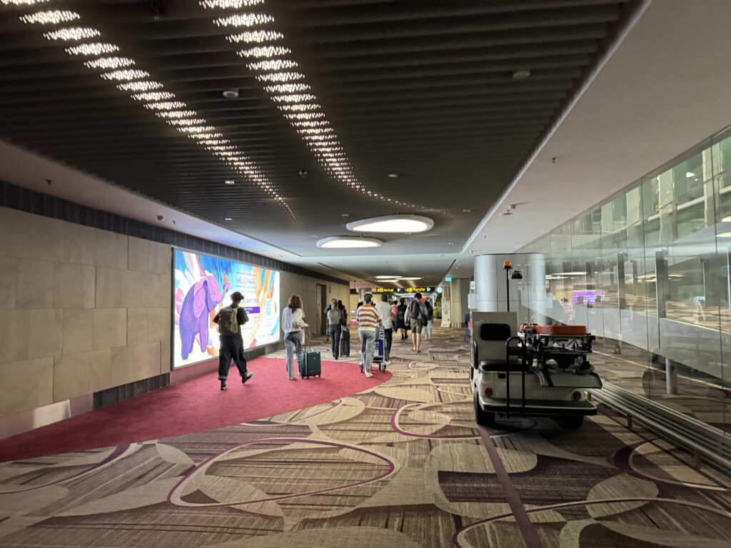 a group of people walking in a hallway