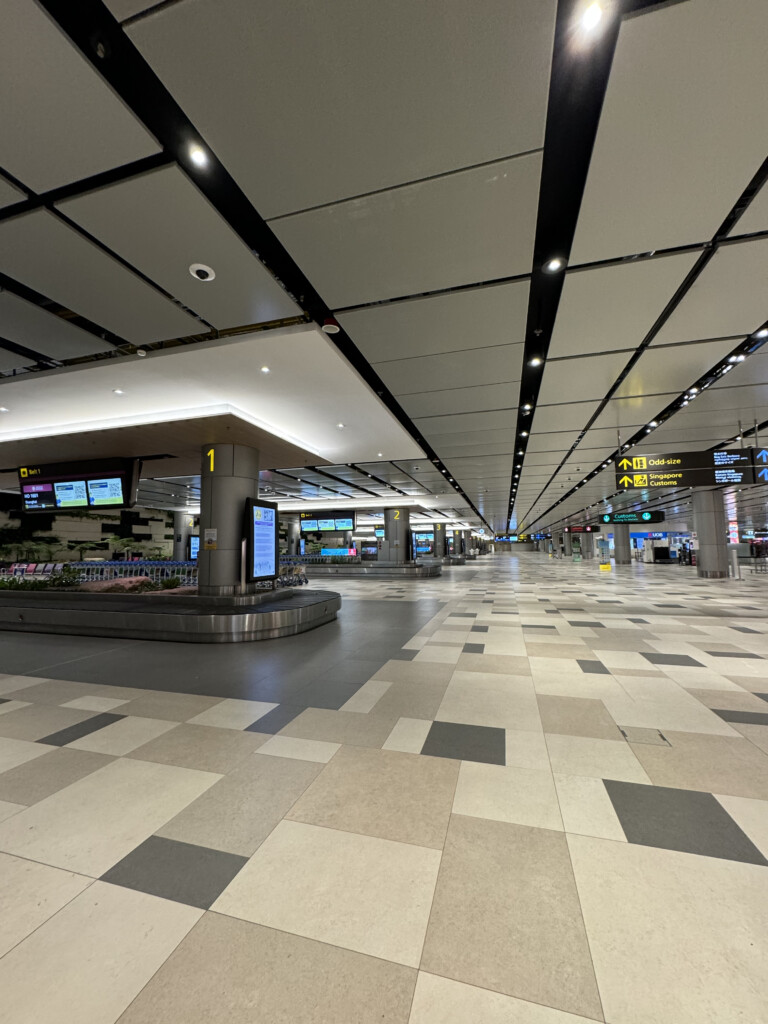 an airport with signs and luggage