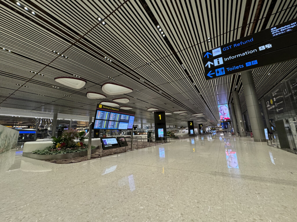 a large airport terminal with signs and information signs