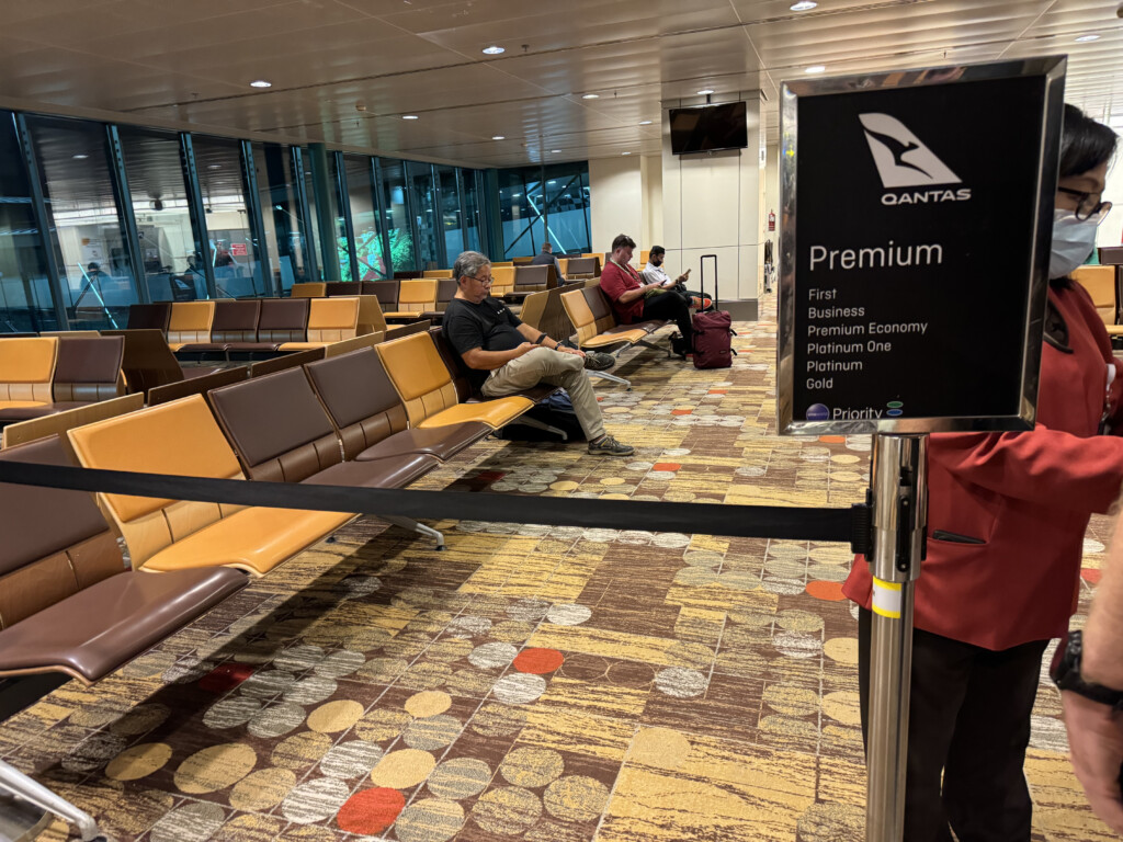 people sitting in a row of benches