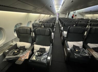 a plane with seats and people in the background