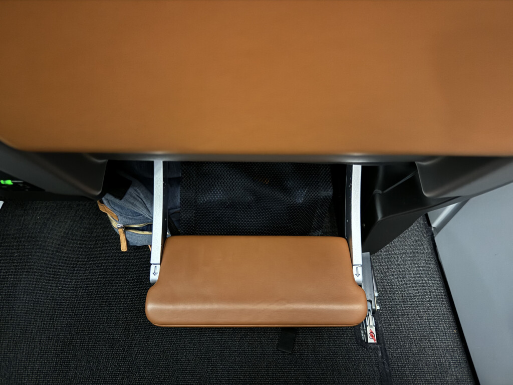 a brown seat with a metal frame