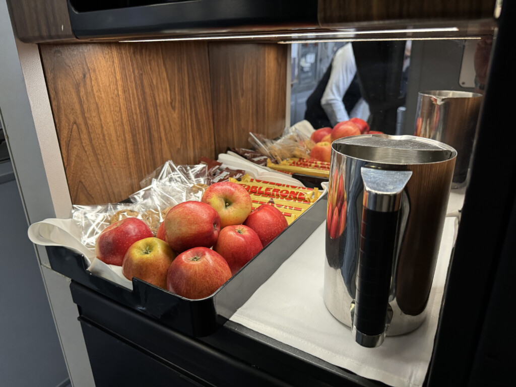 a tray of apples and a pitcher of candy