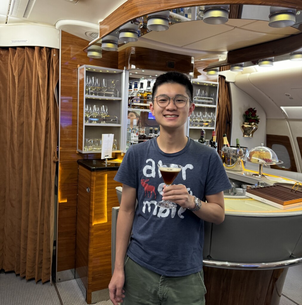 a man holding a drink in a bar