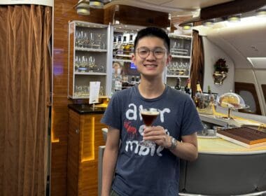 a man holding a drink in a bar