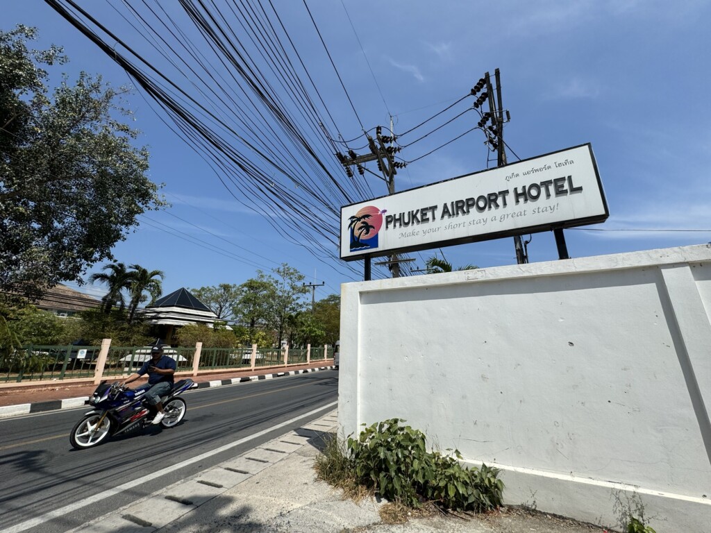 a sign with a person riding a motorcycle on the road