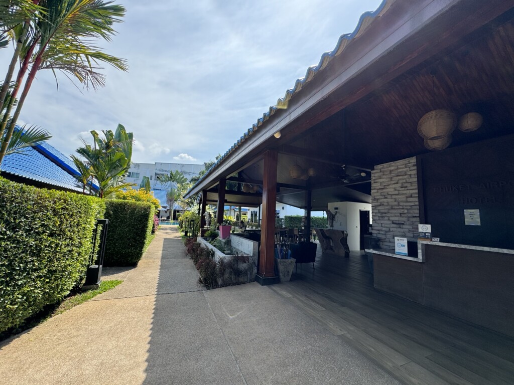 a building with a patio and palm trees