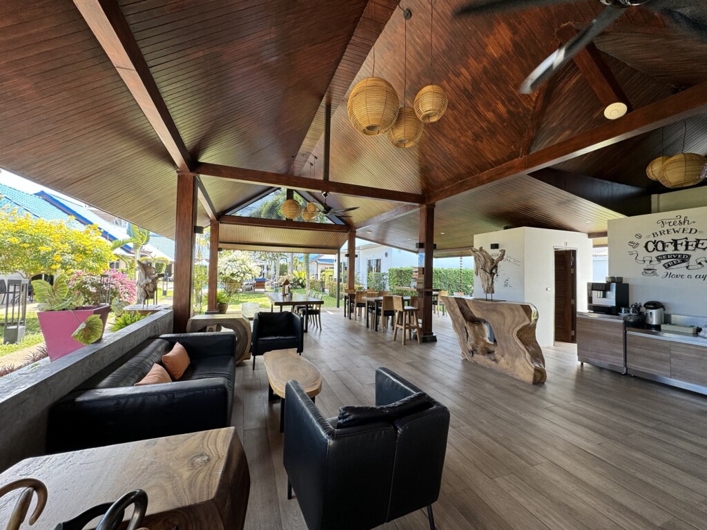 a room with a wood ceiling and a ceiling fan