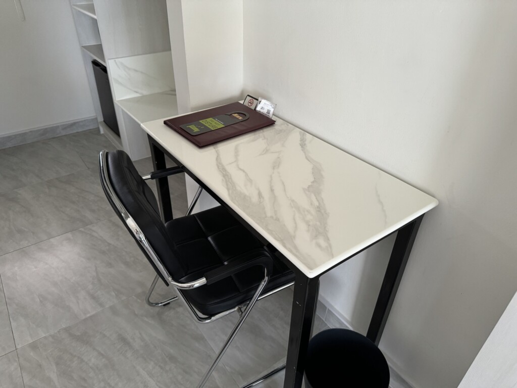 a desk with a chair and a book on it