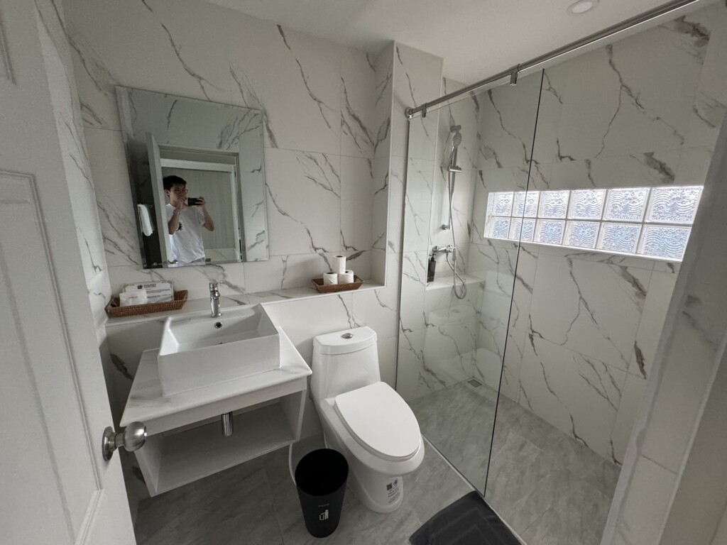 a bathroom with marble walls and a sink and mirror