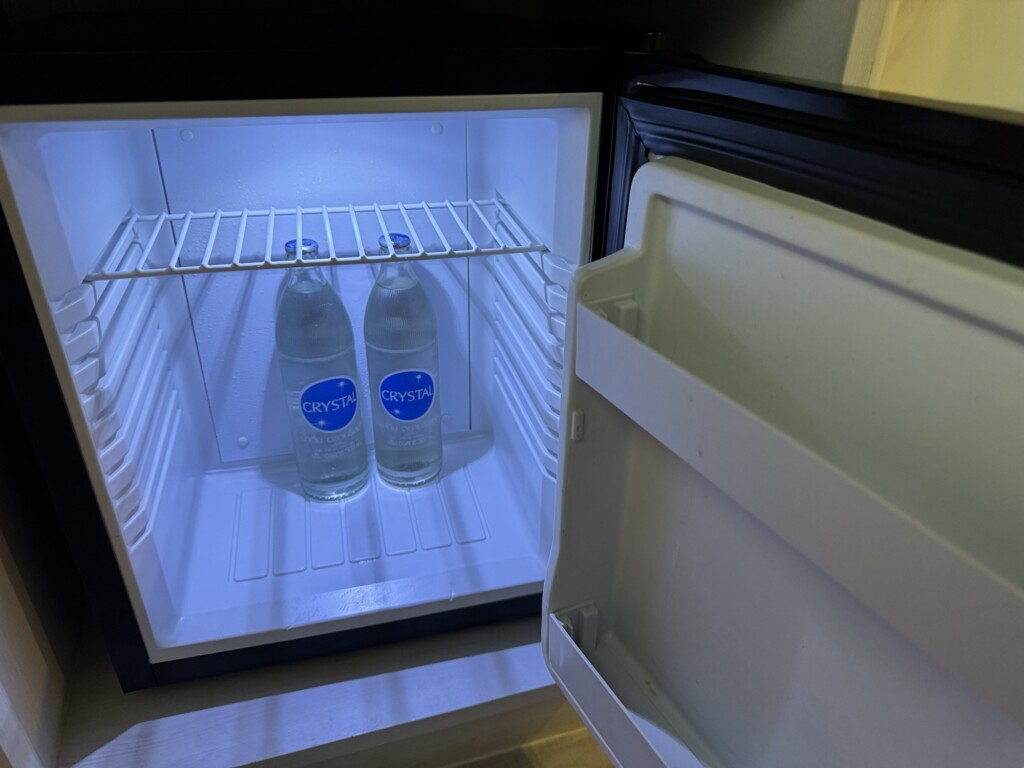 two bottles of water inside a mini fridge