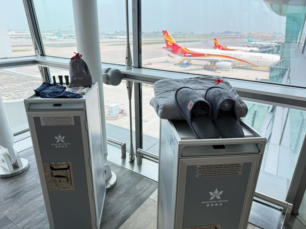 a pair of grey metal boxes with slippers on top and a pair of towels on top