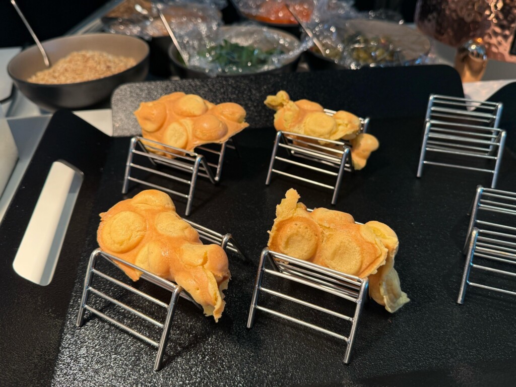 a group of small metal baskets with food on them