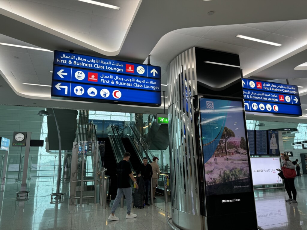 people in a building with signs and a sign
