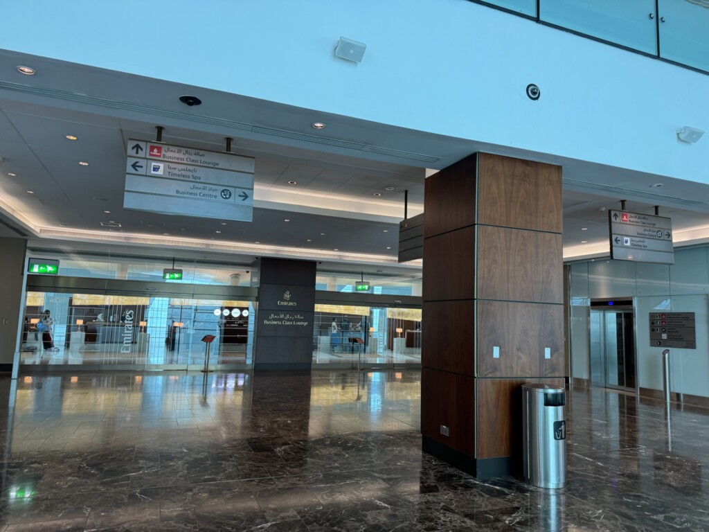 a large building with a large pillar and signs
