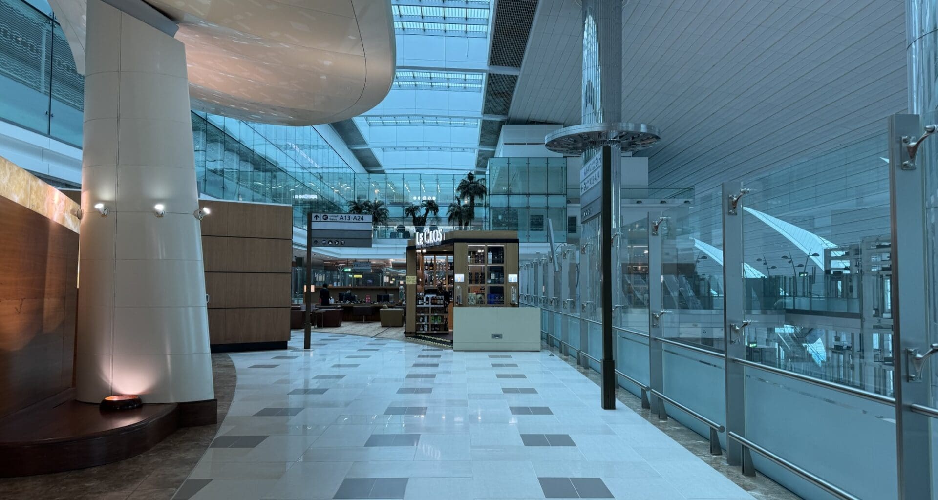 a hallway with glass walls and a shelf