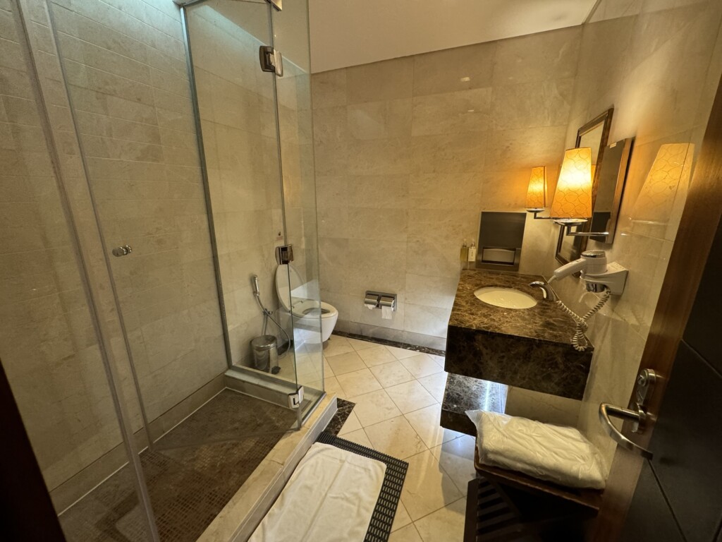 a bathroom with a glass shower and sink
