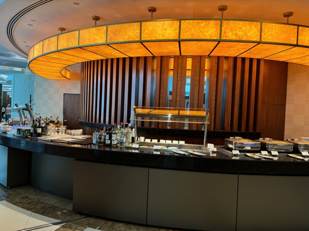 a bar with a counter and bottles of alcohol