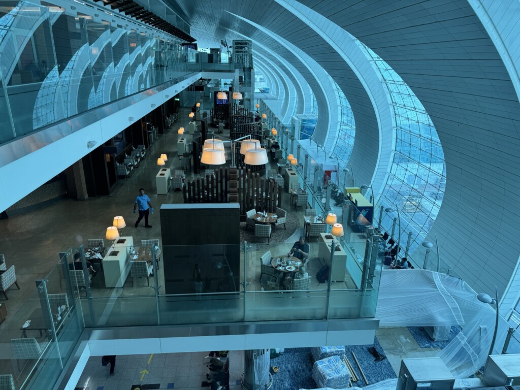 a building with a glass ceiling and a man walking