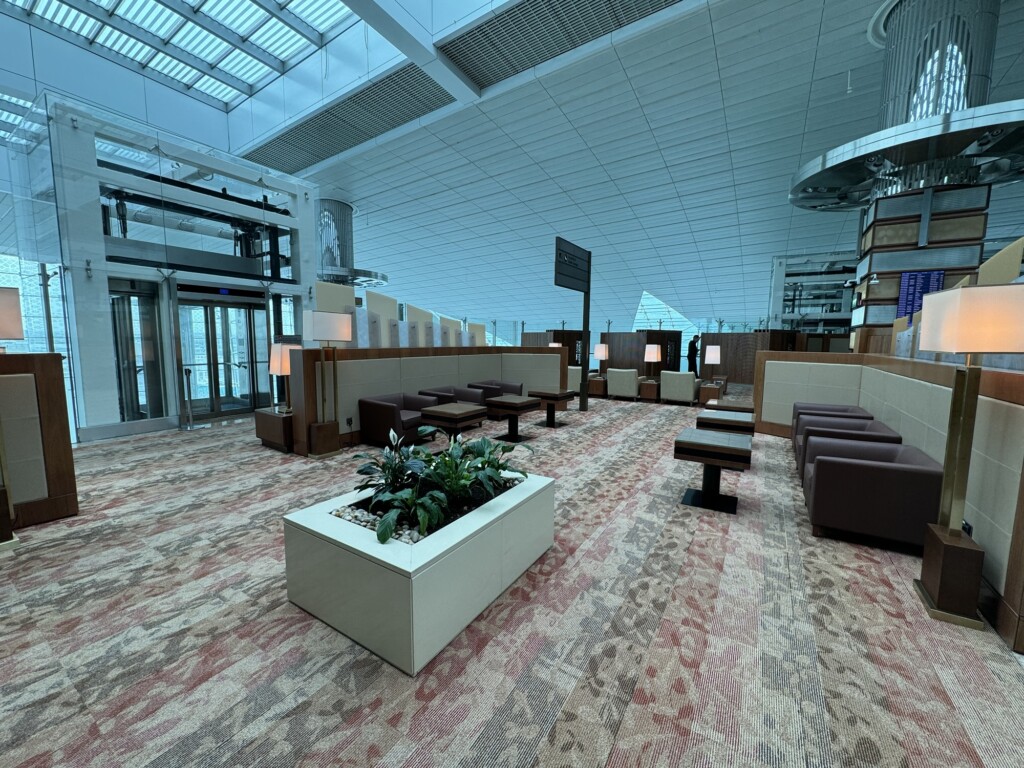 a room with a large window and a planter