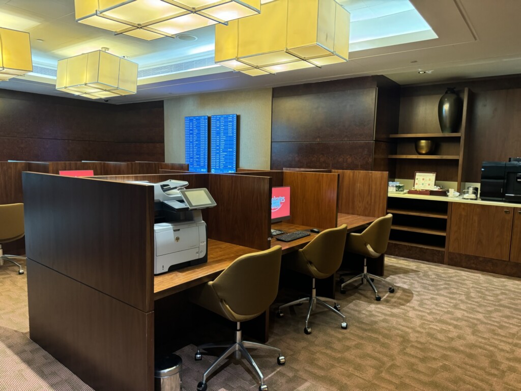 a room with a desk and chairs