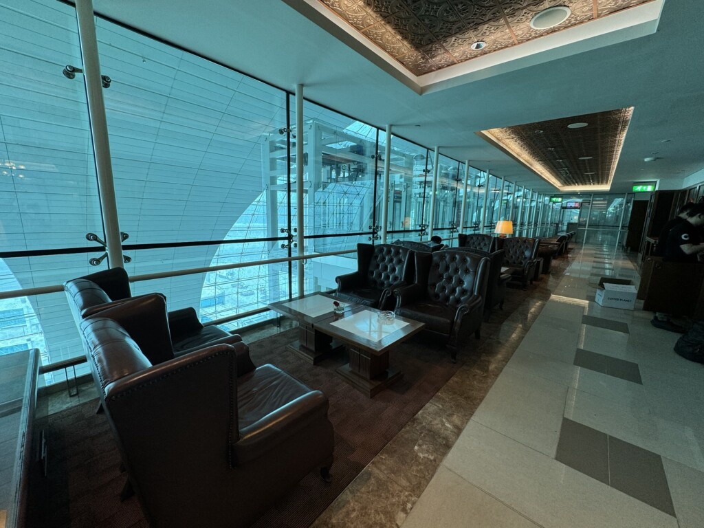 a room with leather couches and tables