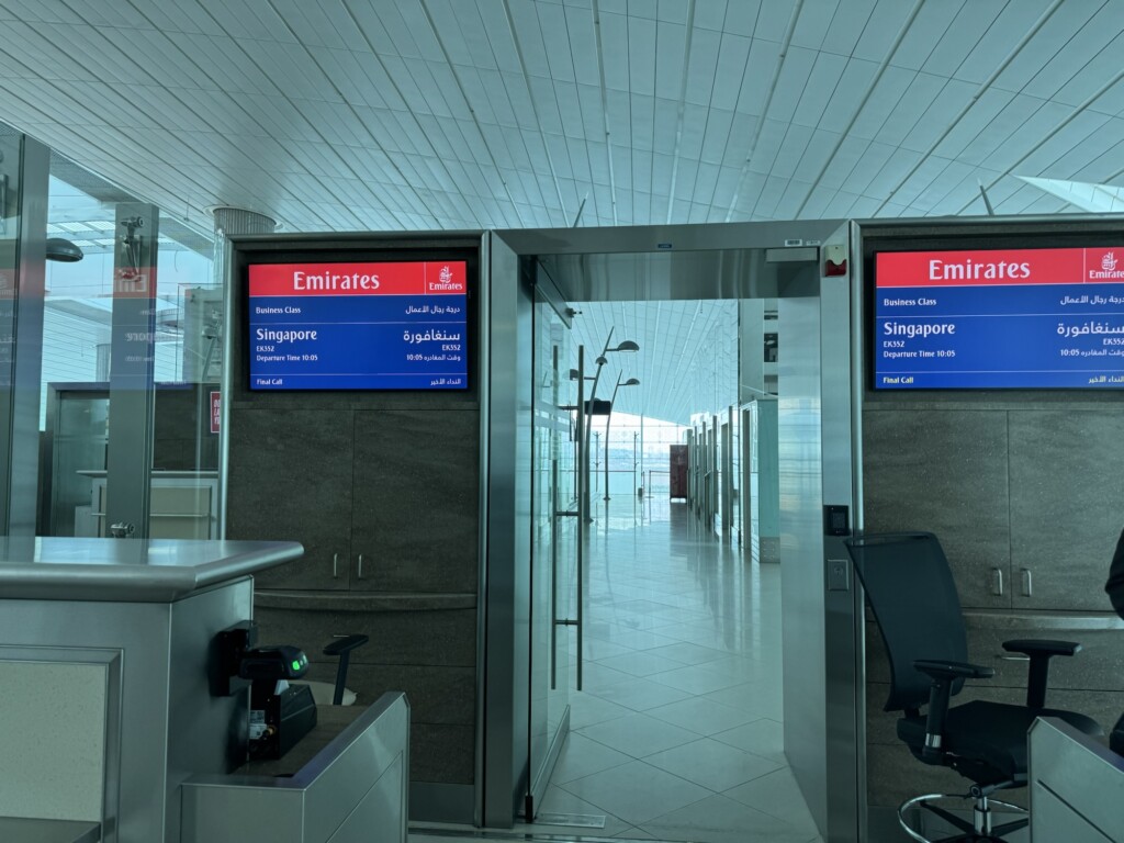 an airport with a sign and a desk