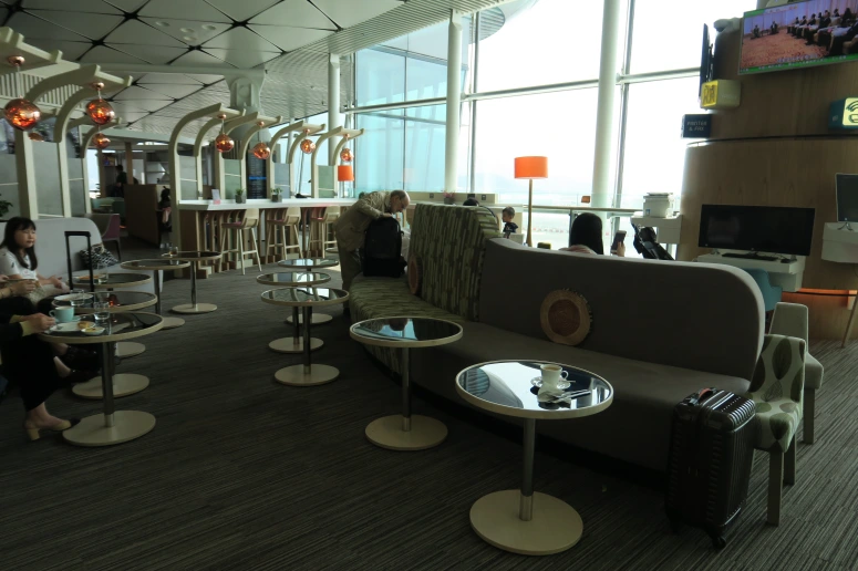 a room with a couch and tables and chairs