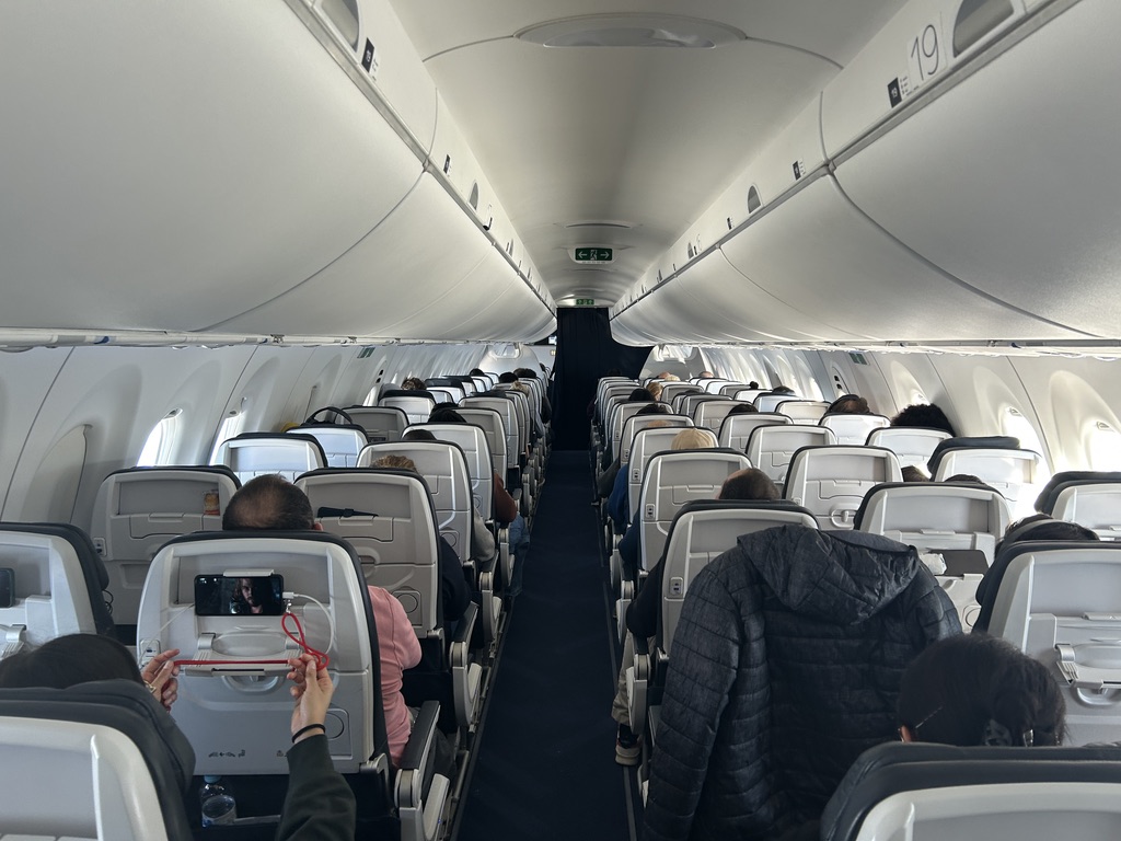 a group of people sitting in an airplane