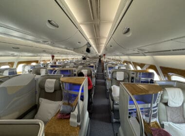 inside an airplane with seats and people sitting on it