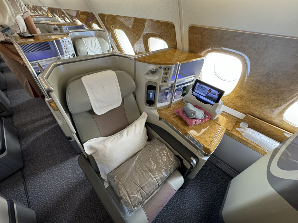 a seat with a laptop and a table in the middle of the seat