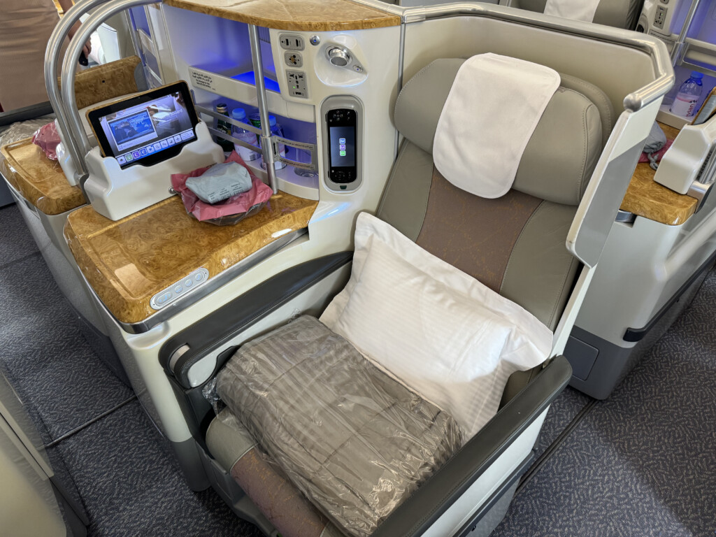 a seat with a pillow and a bed