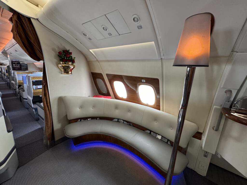 a white couch and a floor lamp in an airplane