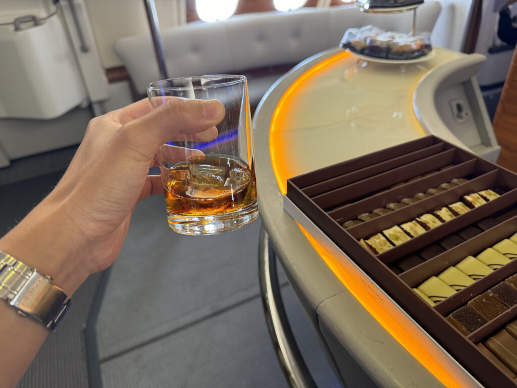 a hand holding a glass of alcohol