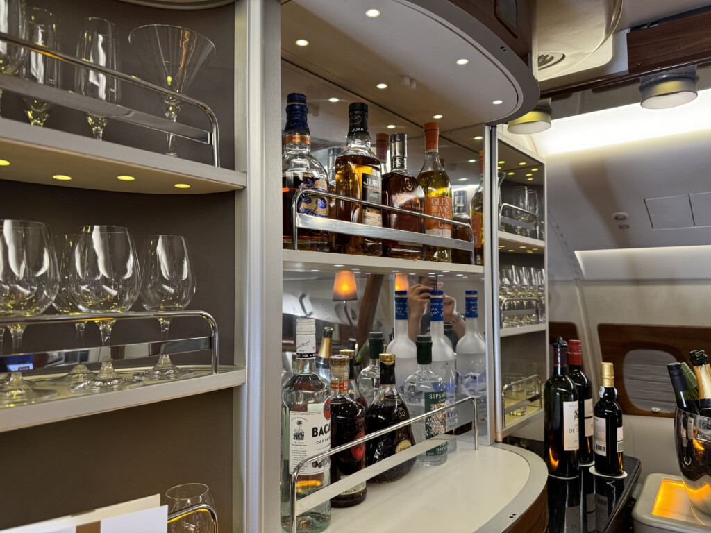 a shelf with bottles and glasses