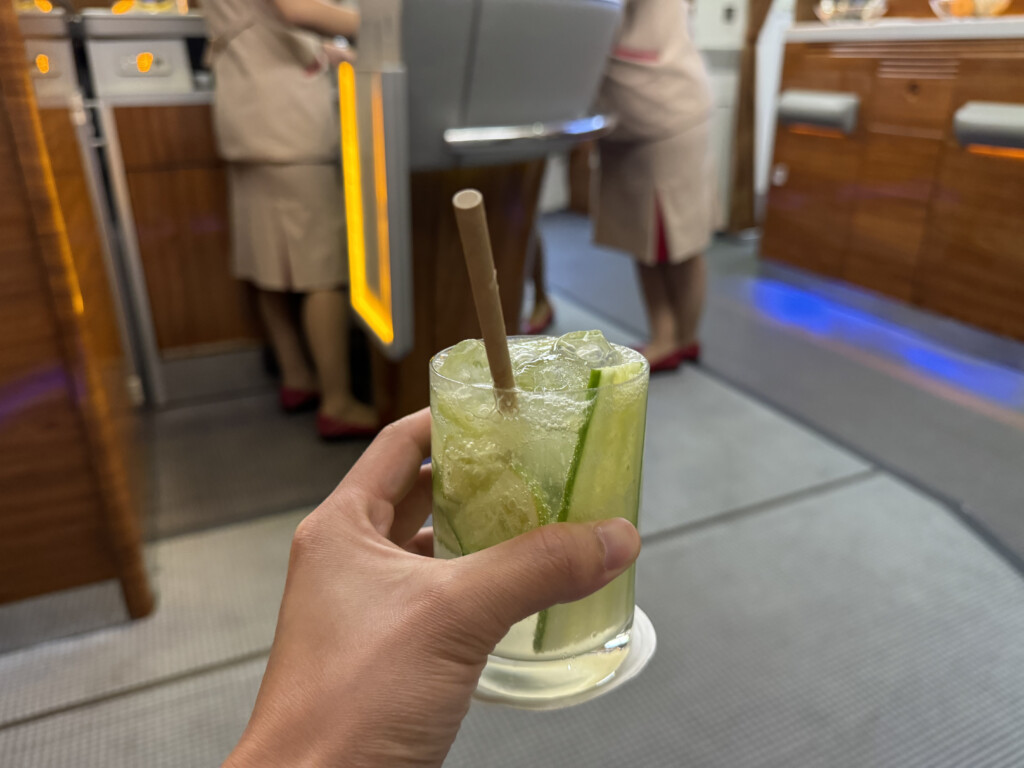 a hand holding a drink with a straw