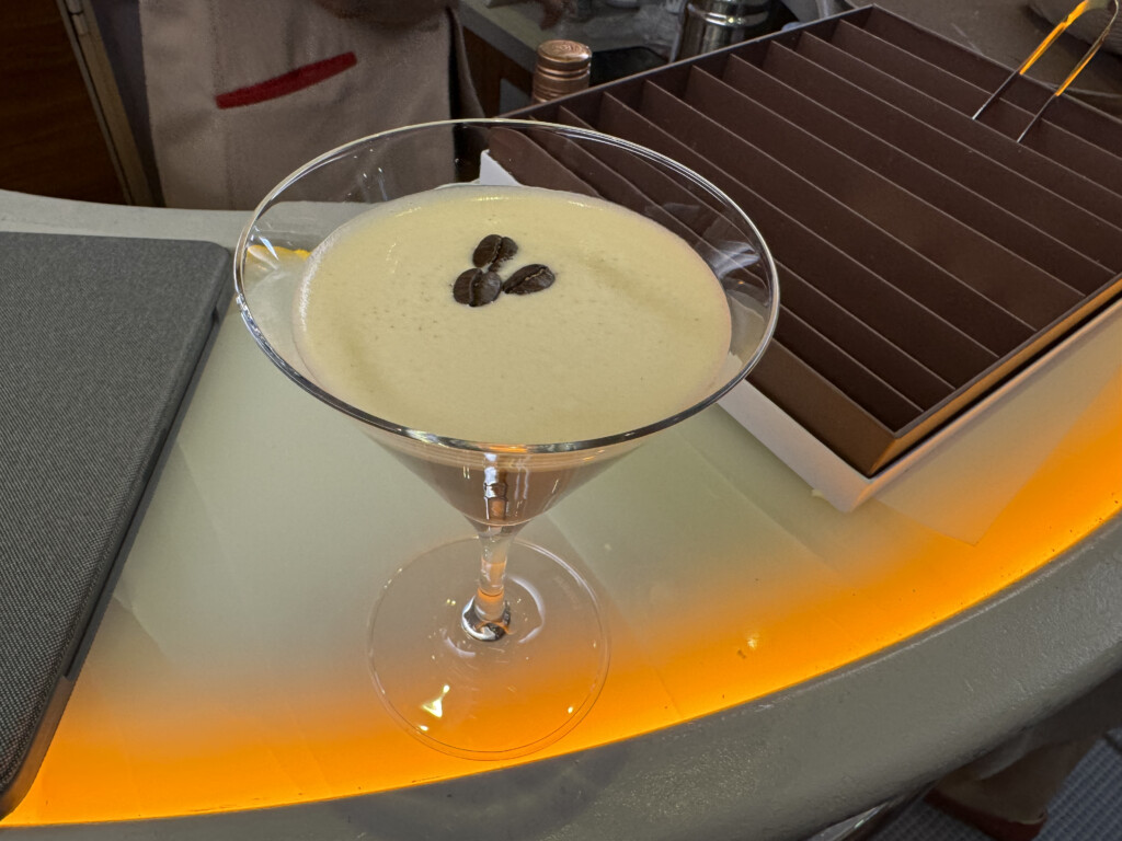 a martini glass with coffee beans on top