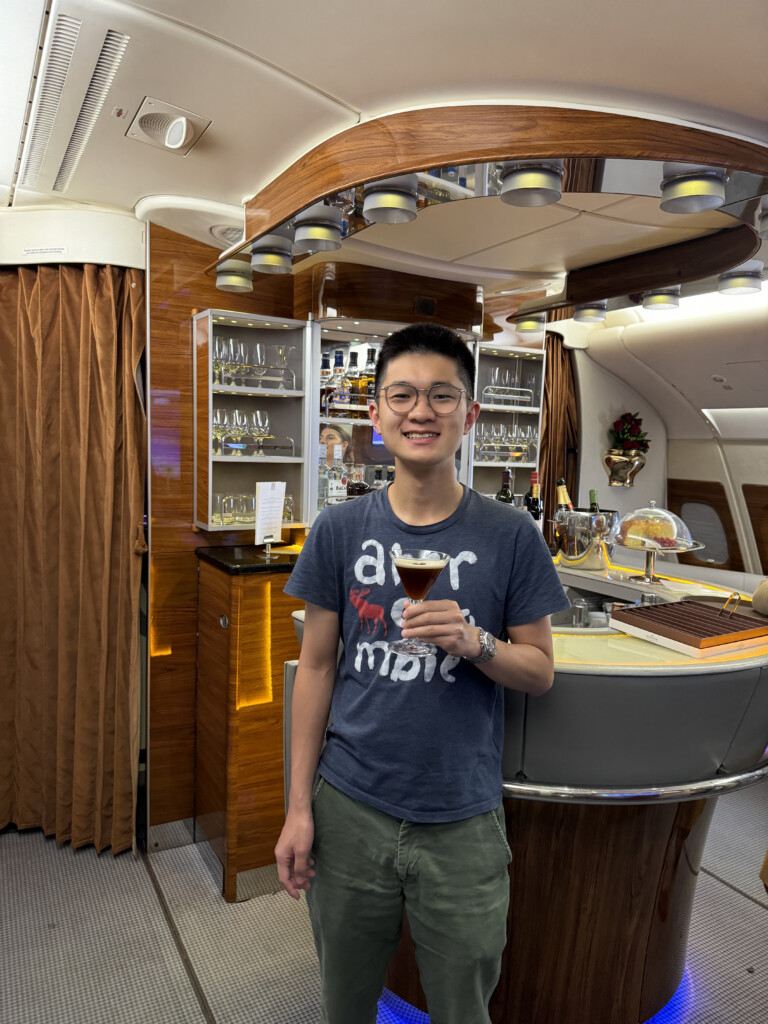 a man holding a drink in a plane