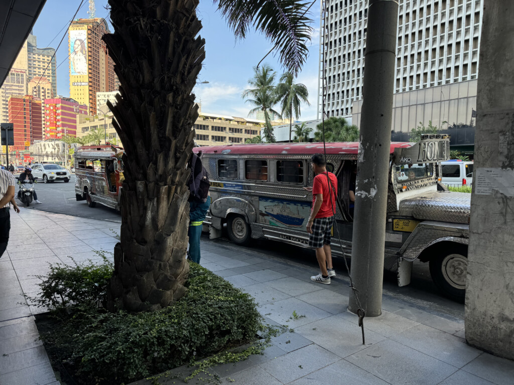 a group of people standing next to a bus