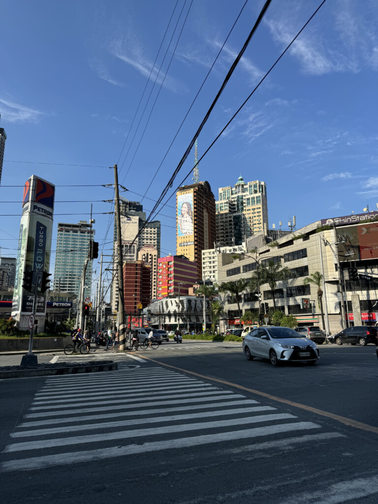 a car on a street with buildings in the background