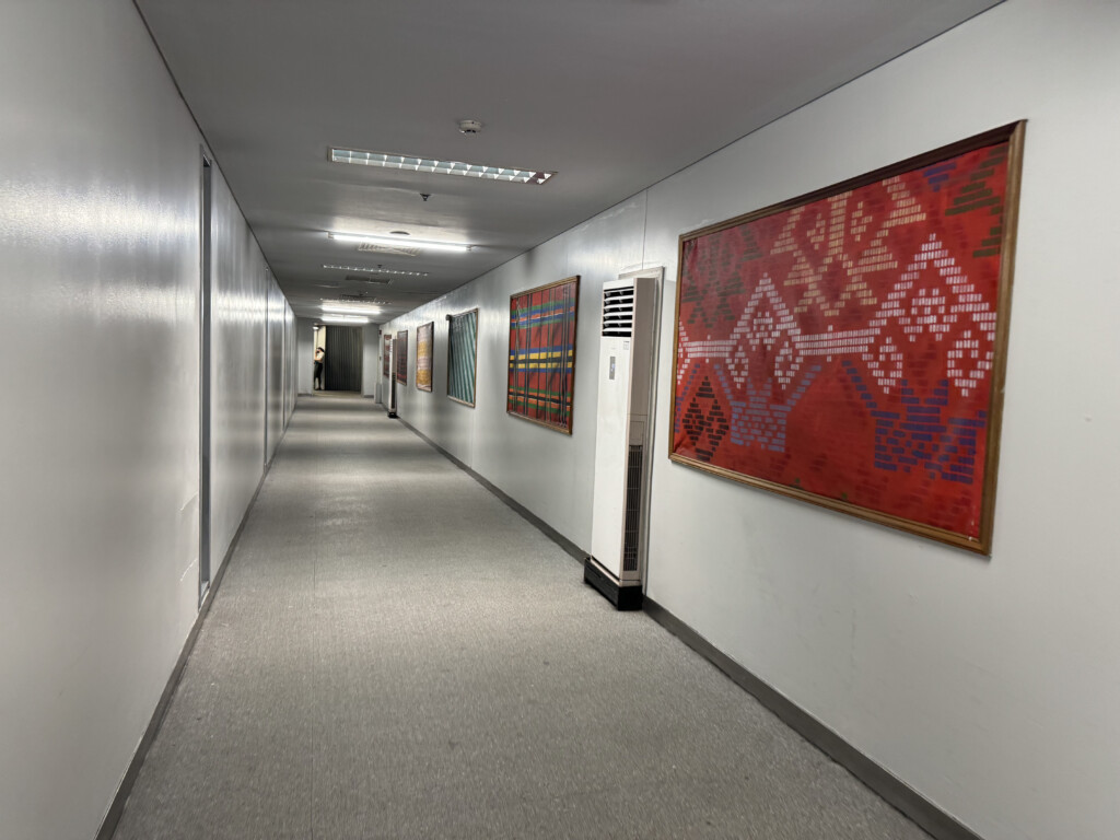 a long hallway with art on the wall