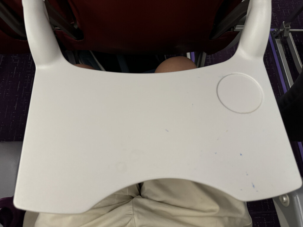 a white plastic chair with a round object on it