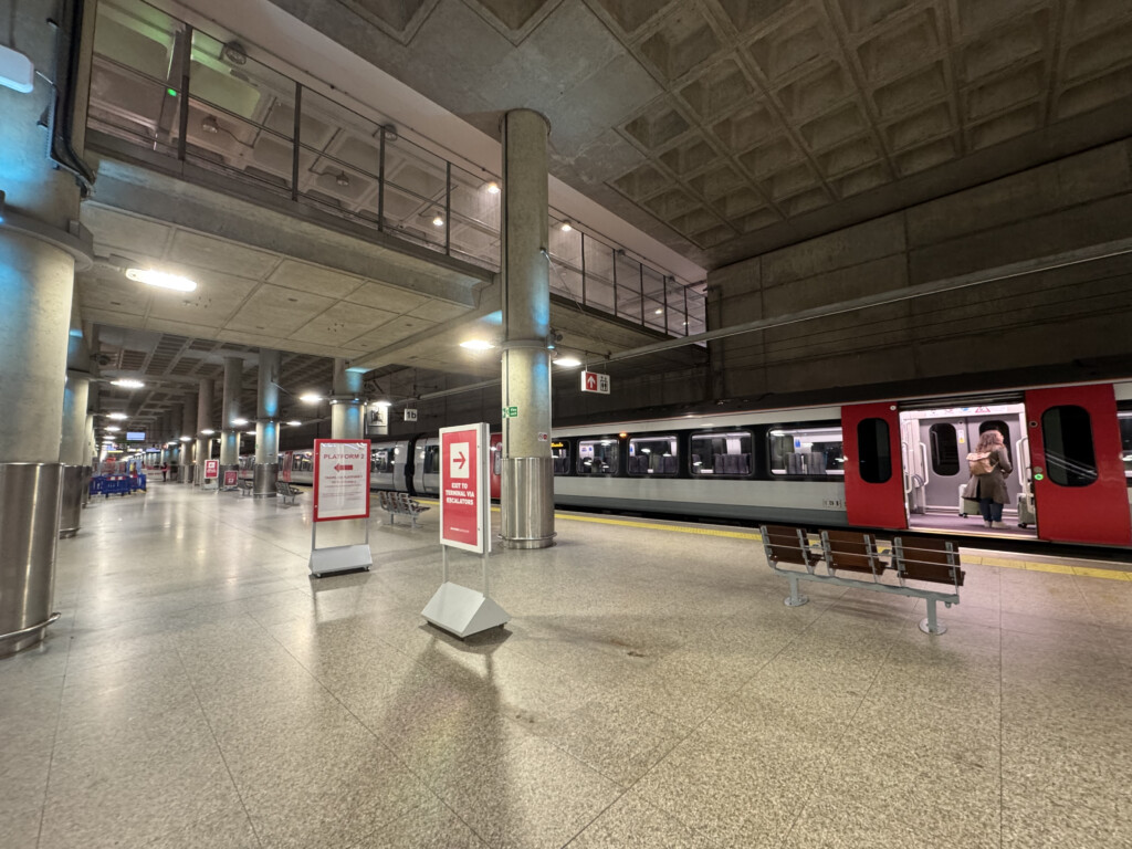 a train station with a train and people