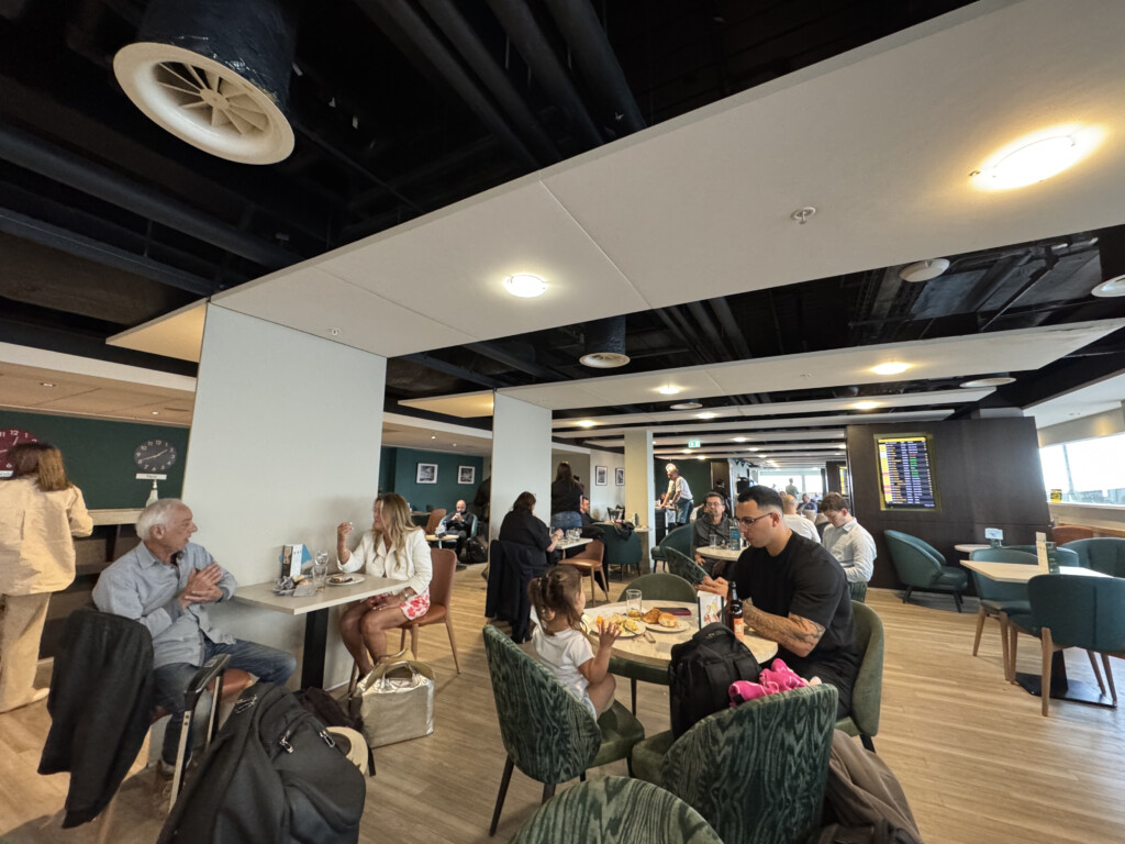 a group of people sitting at tables in a restaurant